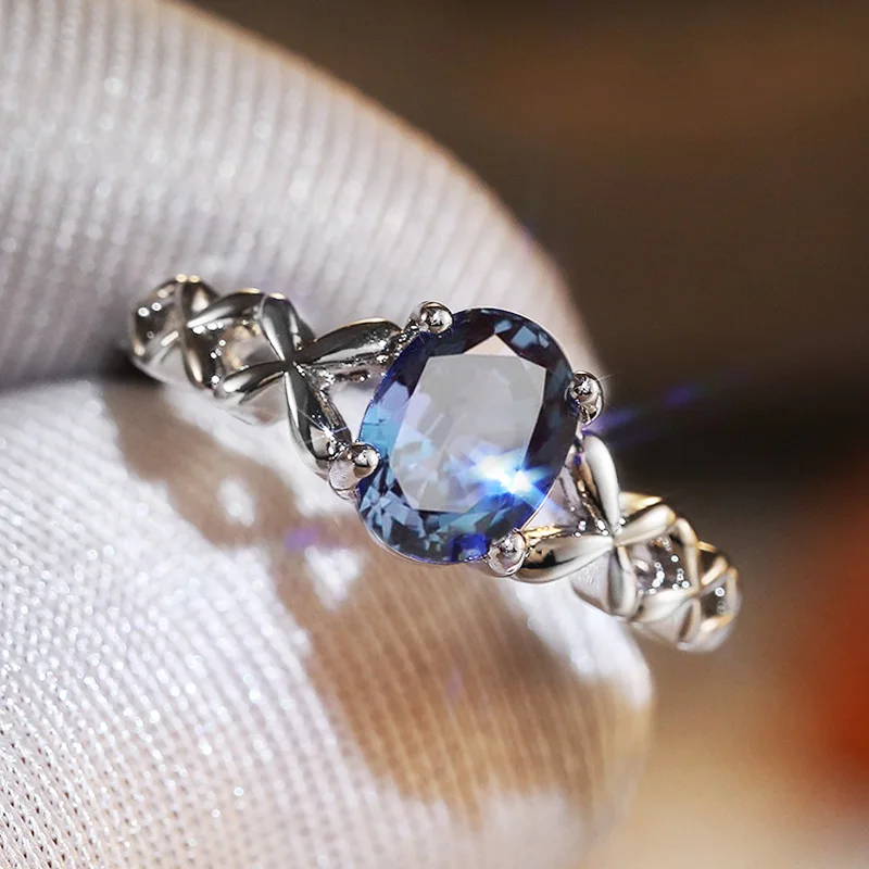 Huitan romantische Solitär blau oval cz Ring für Frauen mit ausgefallenen Kreuz schnur Design Hochzeitstag Party Modeschmuck