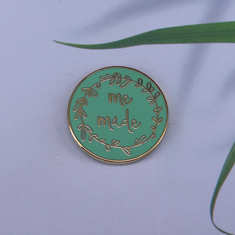 Show off your me-made outfits in style with this super shiny mint enamel pin by Pink Coat Club!