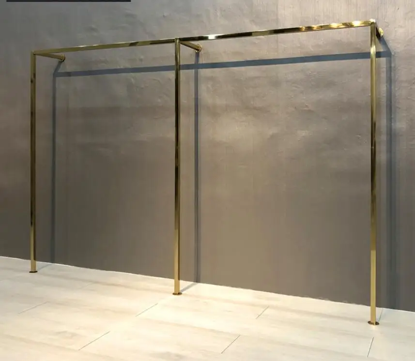 Titanium gold stainless steel display stand on the wall of clothing store