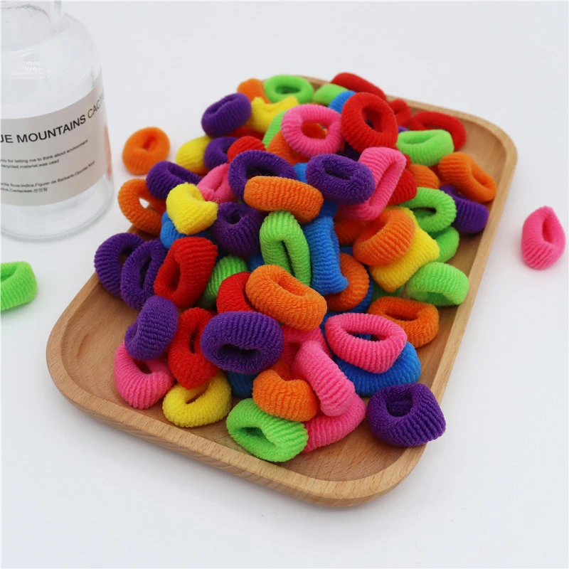 50/100pcs neonate piccole fasce per capelli elastici porta coda di cavallo per bambini fascia per capelli cravatte colorate Mini elastico accessori per capelli