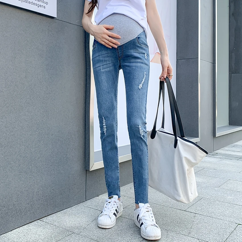 

Spring and autumn new pregnant women's pants stomach lift denim nine points pants fashion wild hole slim feet pants