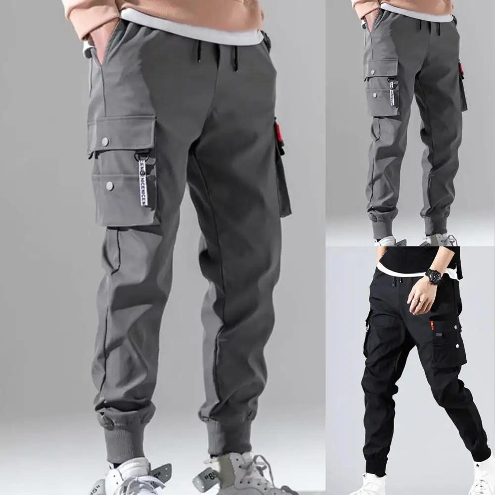 Männer Mode Hosen mehrere Taschen elastische Taille Kordel zug Hip Hop Jogger Hose einfarbig dünne männliche Männer Balken Füße Cargo hose