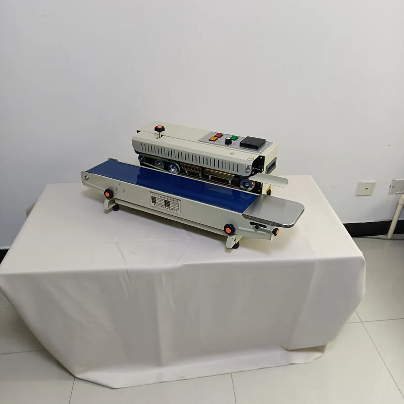 حار بيع آلة الختم المستمر للأكياس البلاستيكية مع آلة ختم الأكياس فيلم الحزام الناقل