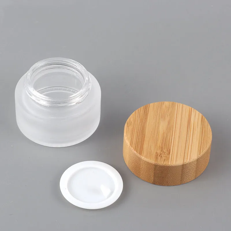 

72pcs Wholesale Cosmetic 5ml 15ml 30ml 50ml 100ml 200g clear frosted glass jar with bamboo wooden lid for body cream