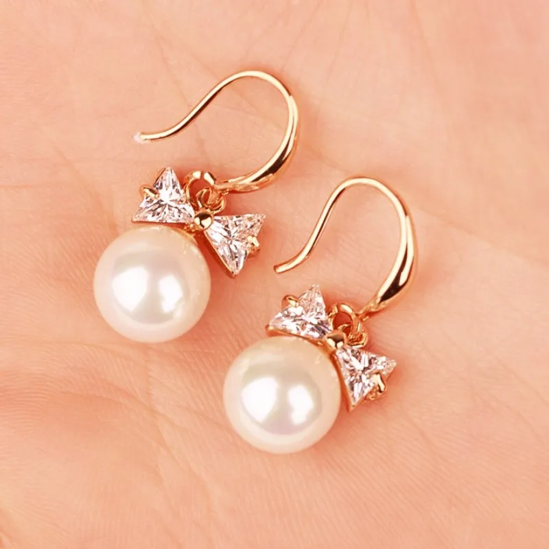 Korean fashion sweet and lovely crystal simulation pearl bow pendant female earrings wholesale