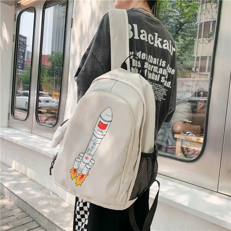 Kawaii Cute Cartoon Rocket Pattern Backpack Unisex and Large Capacity Student Couple Schoolbag To Send Doll Pendant