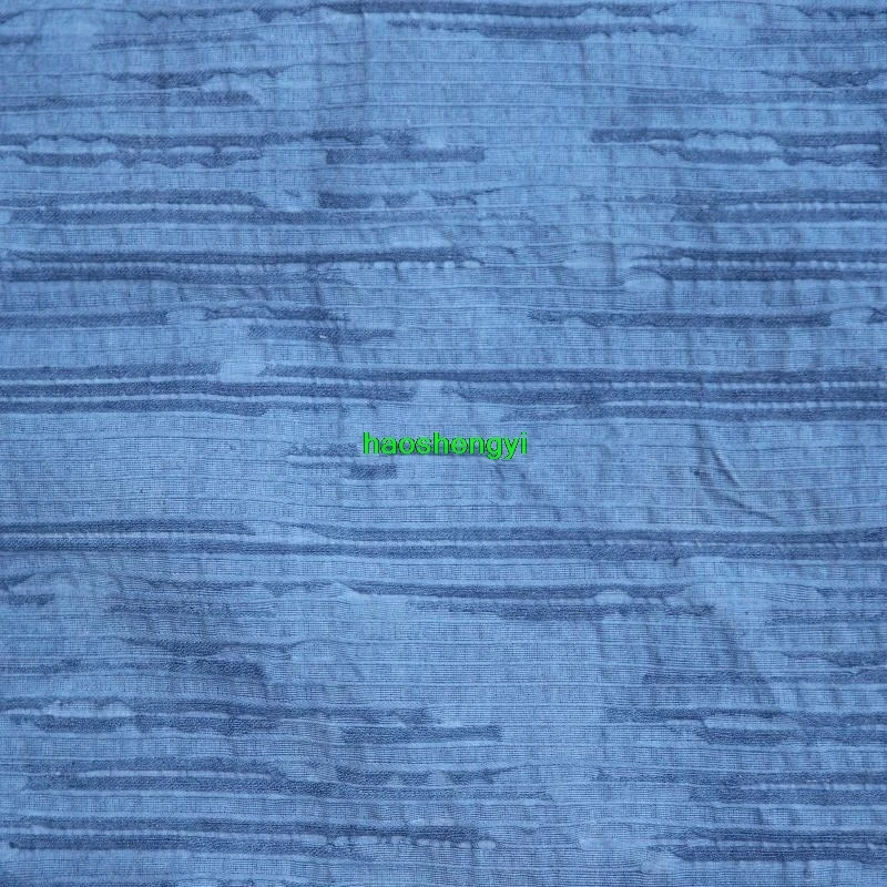 Traditional indigo dyed bark-like pleated cotton and linen garment fabric