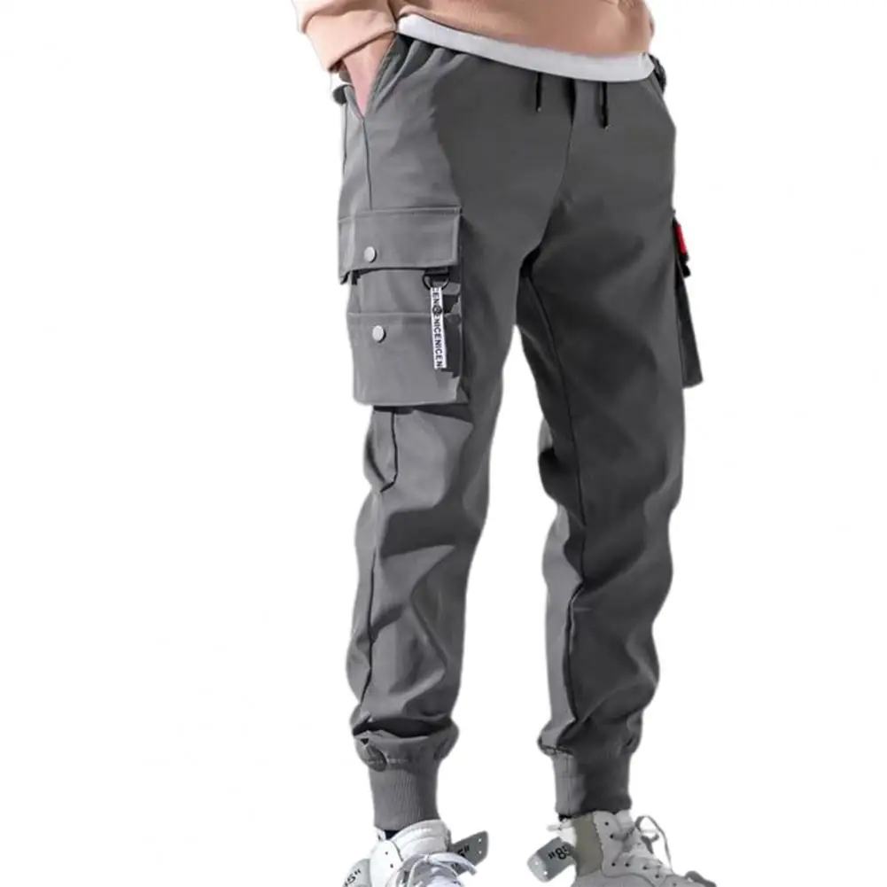 Pantalones de moda con múltiples bolsillos para hombre, pantalones de cintura elástica con cordón, pantalones de Jogger de Hip Hop, pantalones Cargo de pies de haz delgados de Color sólido