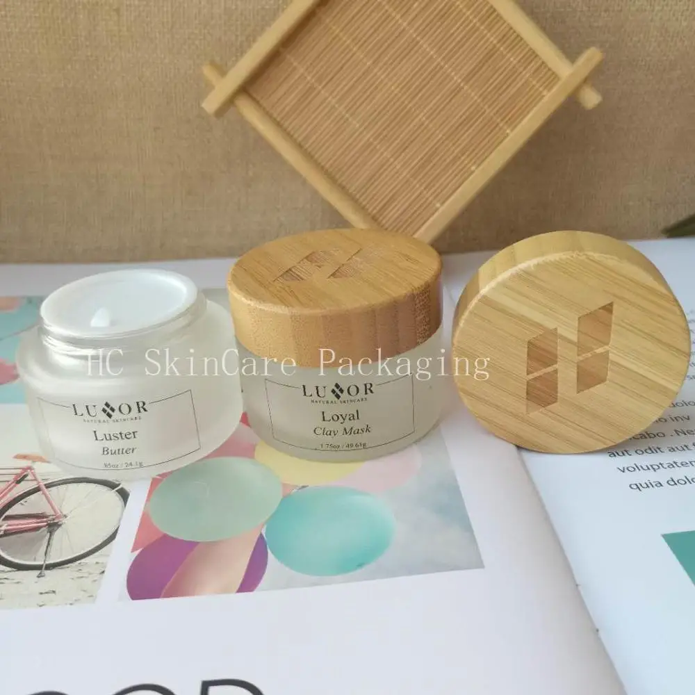 

Wholesale Recycled Frosted Clear Glass With Engraved Bamboo Lid,Cosmetic Cream Jar Glass For Face Cream Packaging