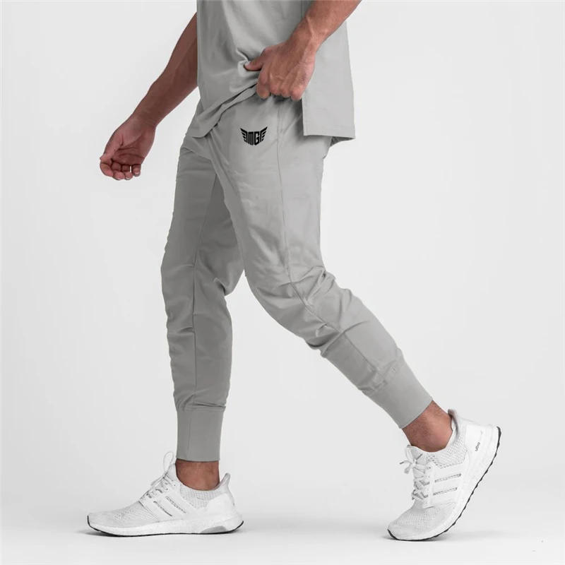 ใหม่ฤดูใบไม้ร่วงกล้ามเนื้อ Mens Fitness วิ่งกางเกงกีฬาผู้ชาย Sweatpants Breathable Slim Fit Beam ปาก Casual Gym กางเกง