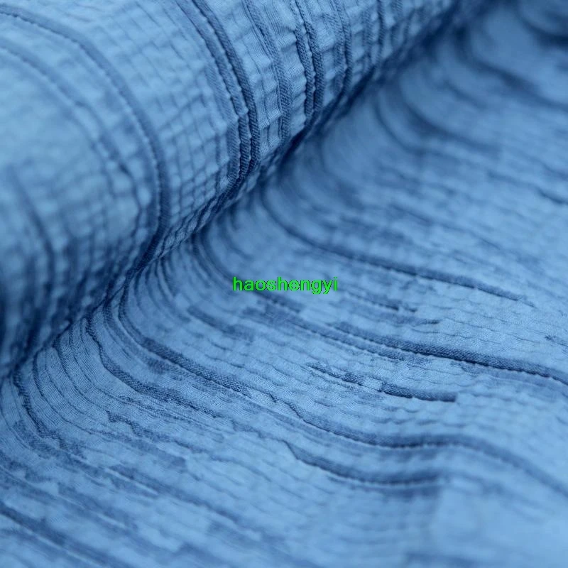 Traditional indigo dyed bark-like pleated cotton and linen garment fabric