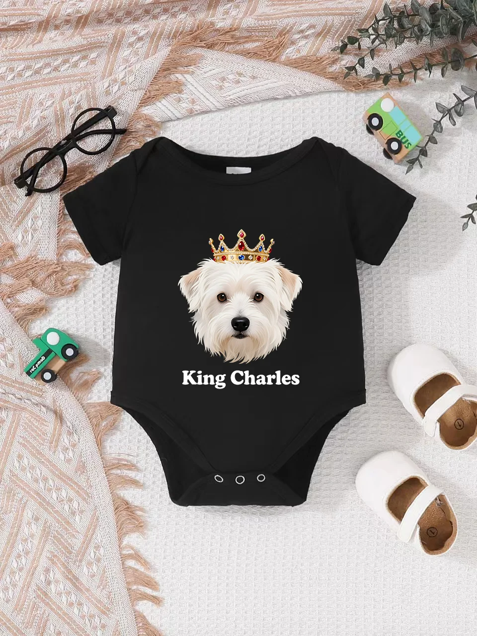 Playful letter-printed baby short-sleeve triangle bodysuit. Button closure for easy dressing