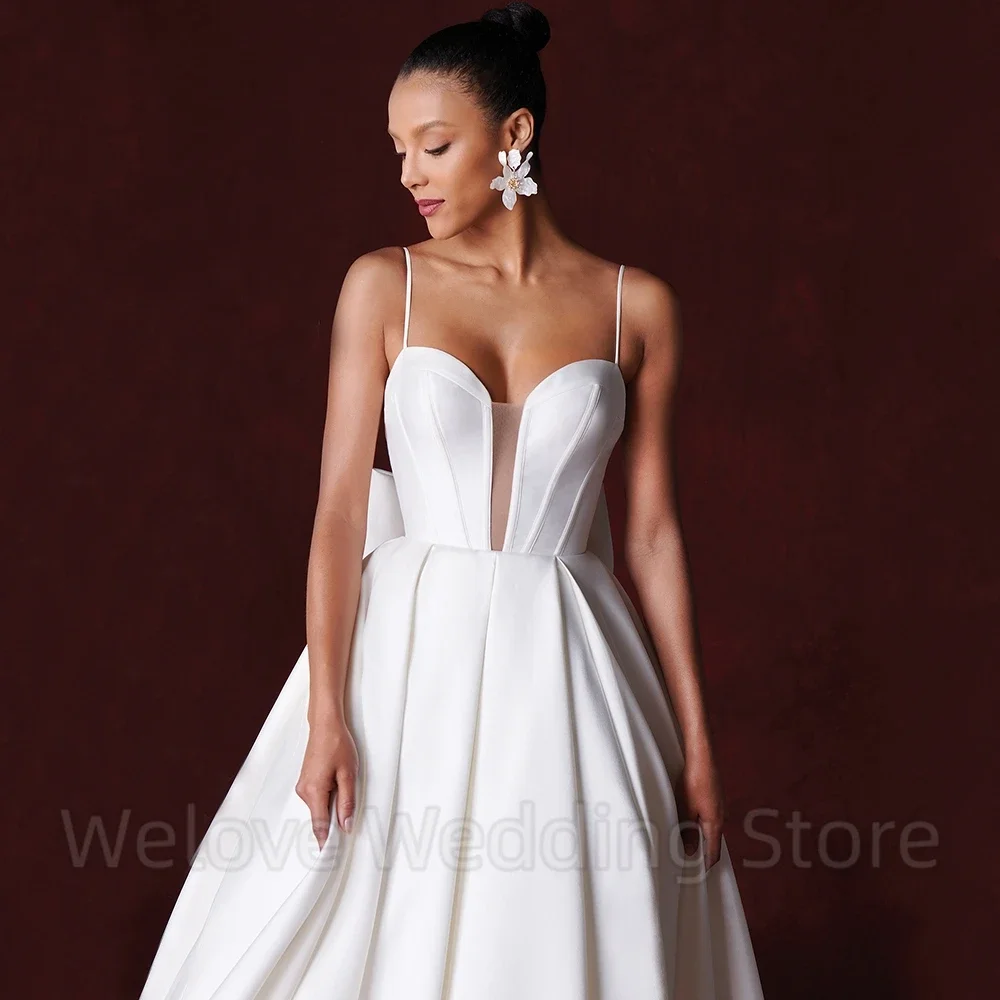 セクシーなオープンバック A ライン ブライダル ウェディング ドレス スパゲッティ ストラップ ノースリーブ リボン付き フロアレングス スイープ トレイン カスタム メイド ガウン