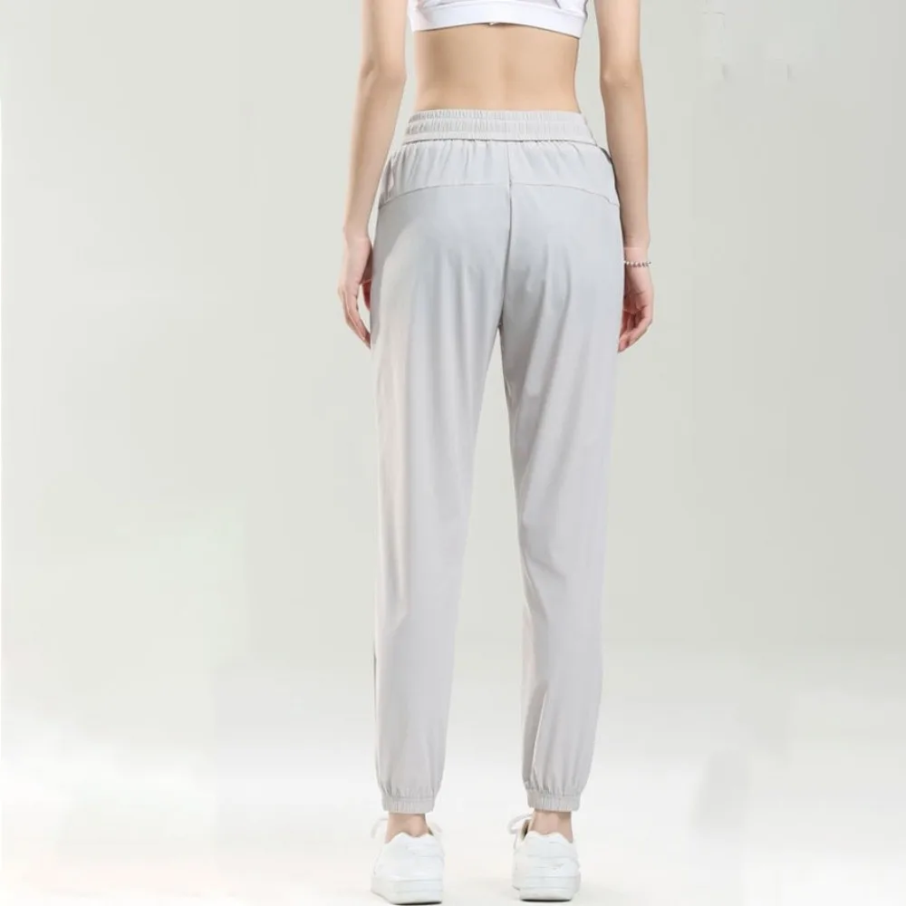 ملابس رياضية سراويل رياضية من الحرير الجليدي فضفاضة بجيب بسحاب سراويل للجري قابلة للتمدد وقابلة للتنفس سراويل لياقة بدنية