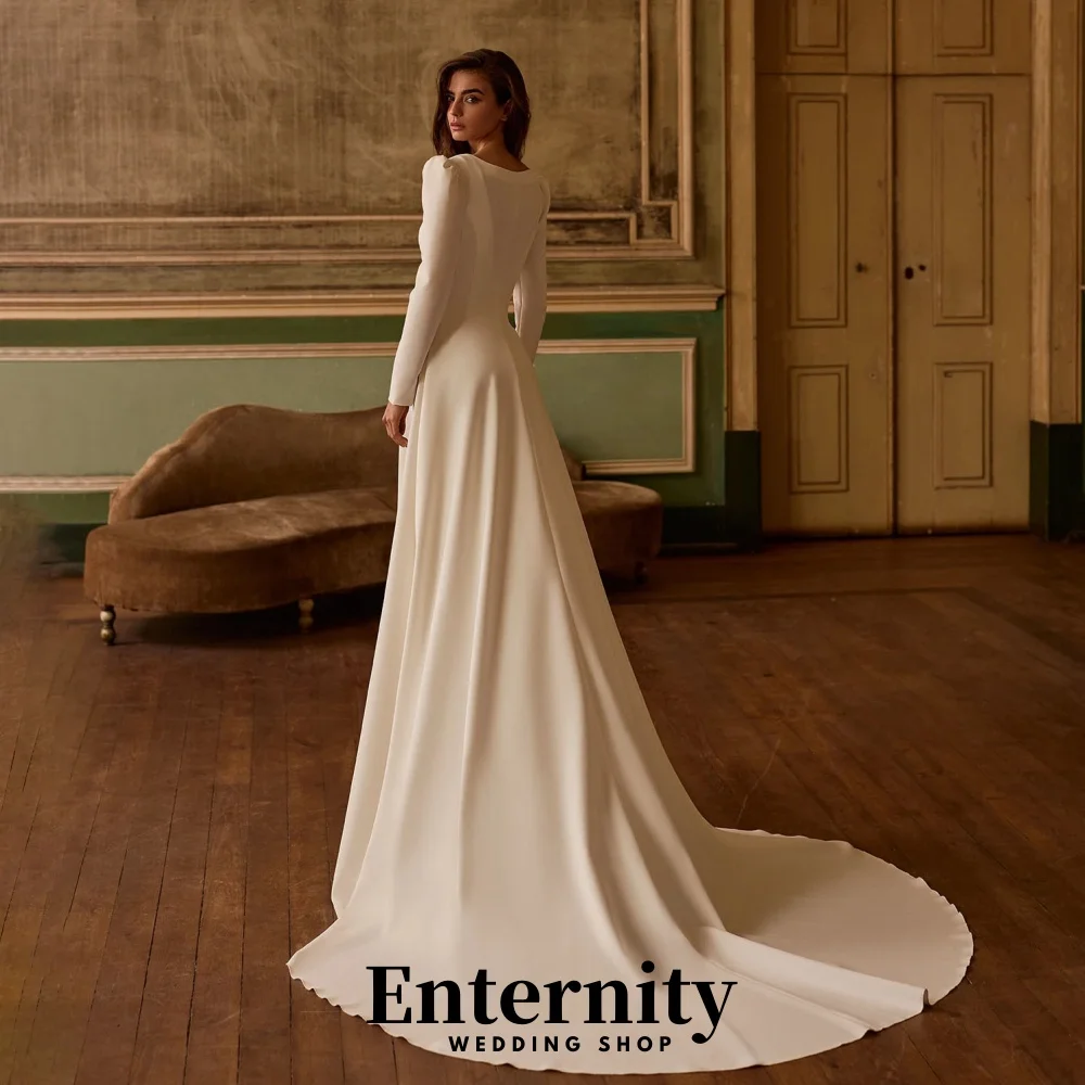 カスタマイズされたバックレスウェディングドレスエレガントなハイネック長袖女性のための魅力的なフリルブライダルガウン Vestidos De Novia