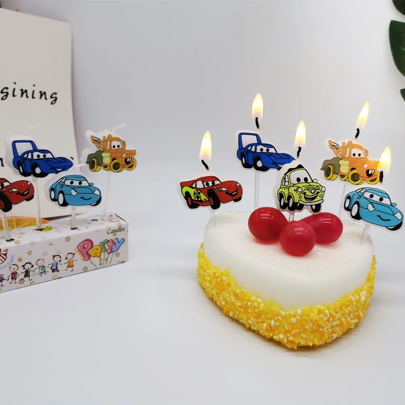 Car with smiling face, birthday candles, cartoon cake decoration