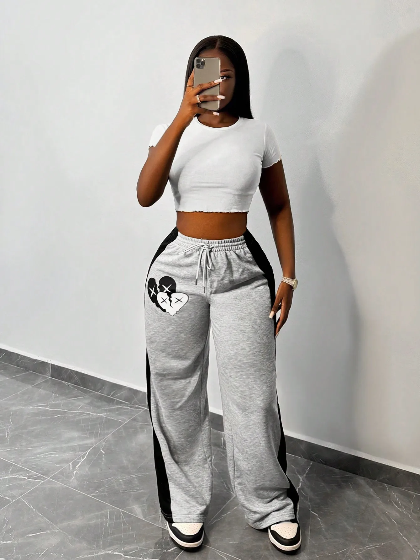 

Женские серые широкие спортивные брюки с графическим принтом в виде сердечек и боковыми полосками