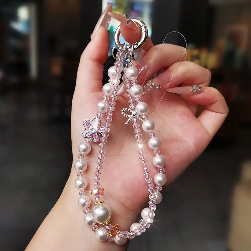 Bracciale da polso con cordino per telefono in cristallo scintillante con catena per telefono con fiocco di lusso e perla per accessori per custodie per telefoni