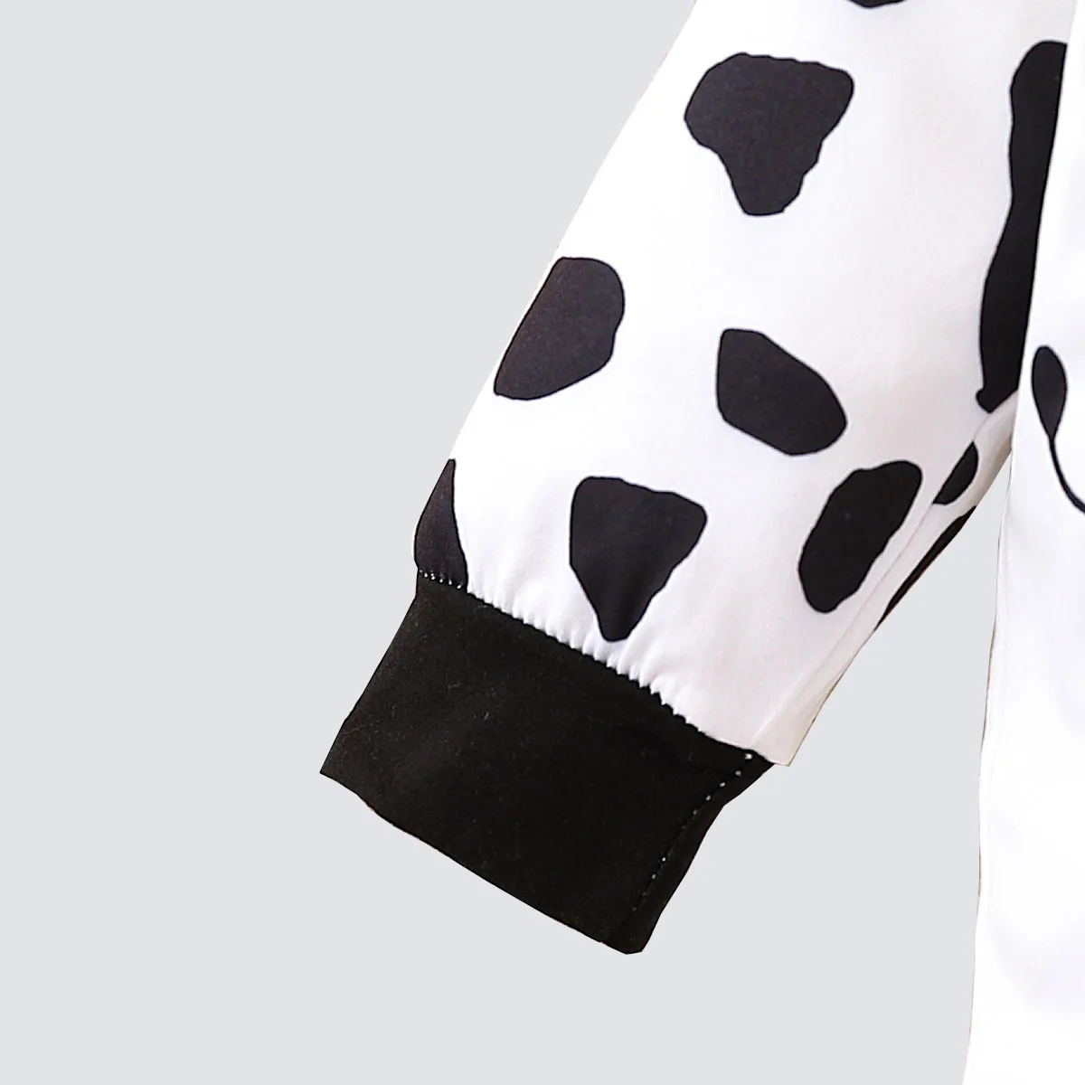 Two piece cute and fashionable black and white spotted cow print long sleeved round neck top and pants set for baby boys