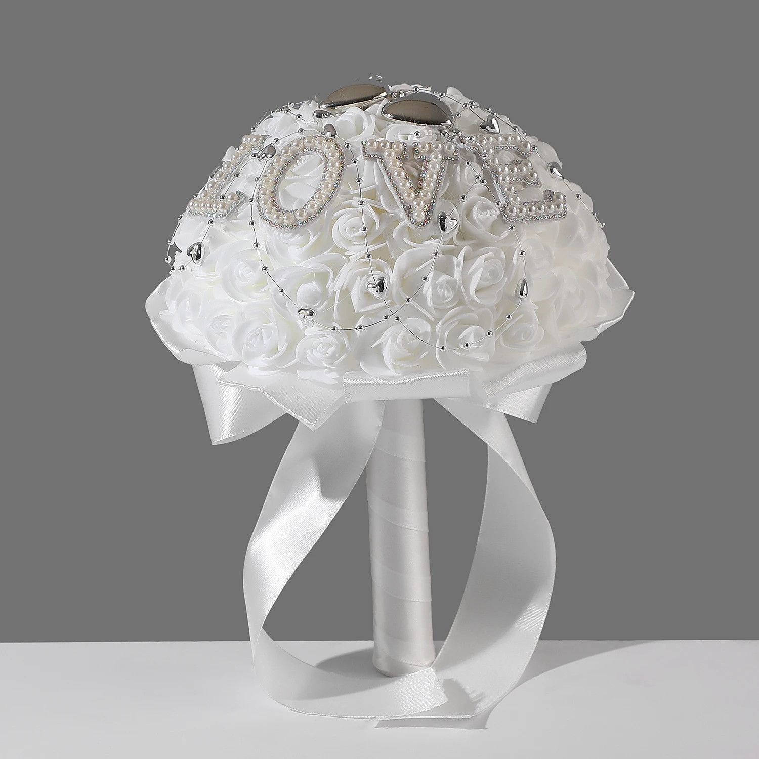 

A white bouquet of roses, made from foam artificial flowers and decorated with the word "love", used by the bride on her wedding