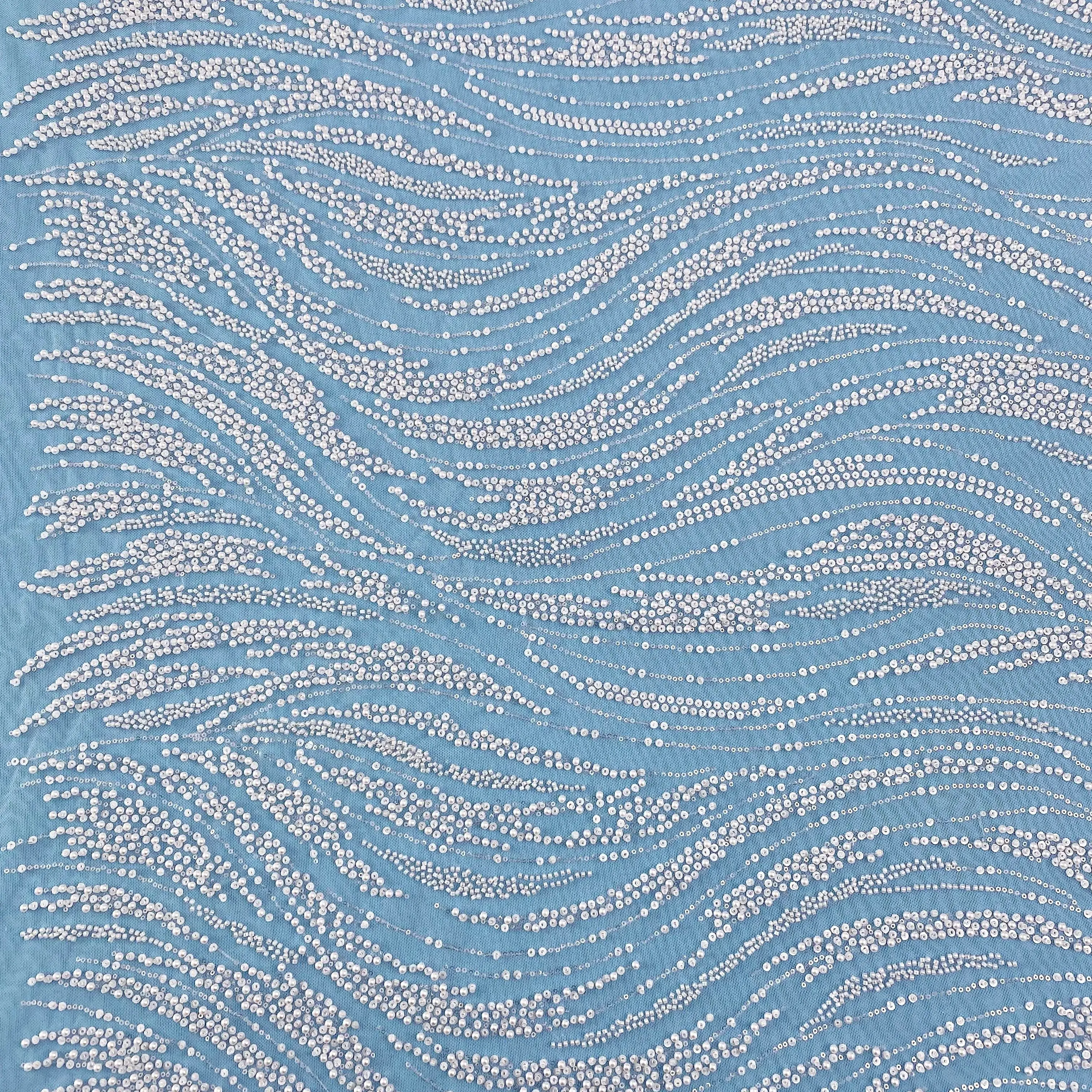 Sumptuous off white Gown Crafted from Luxurious Fabric, Adorned with Intricate White Beaded Wave Motifs—A Paragon of Elegance