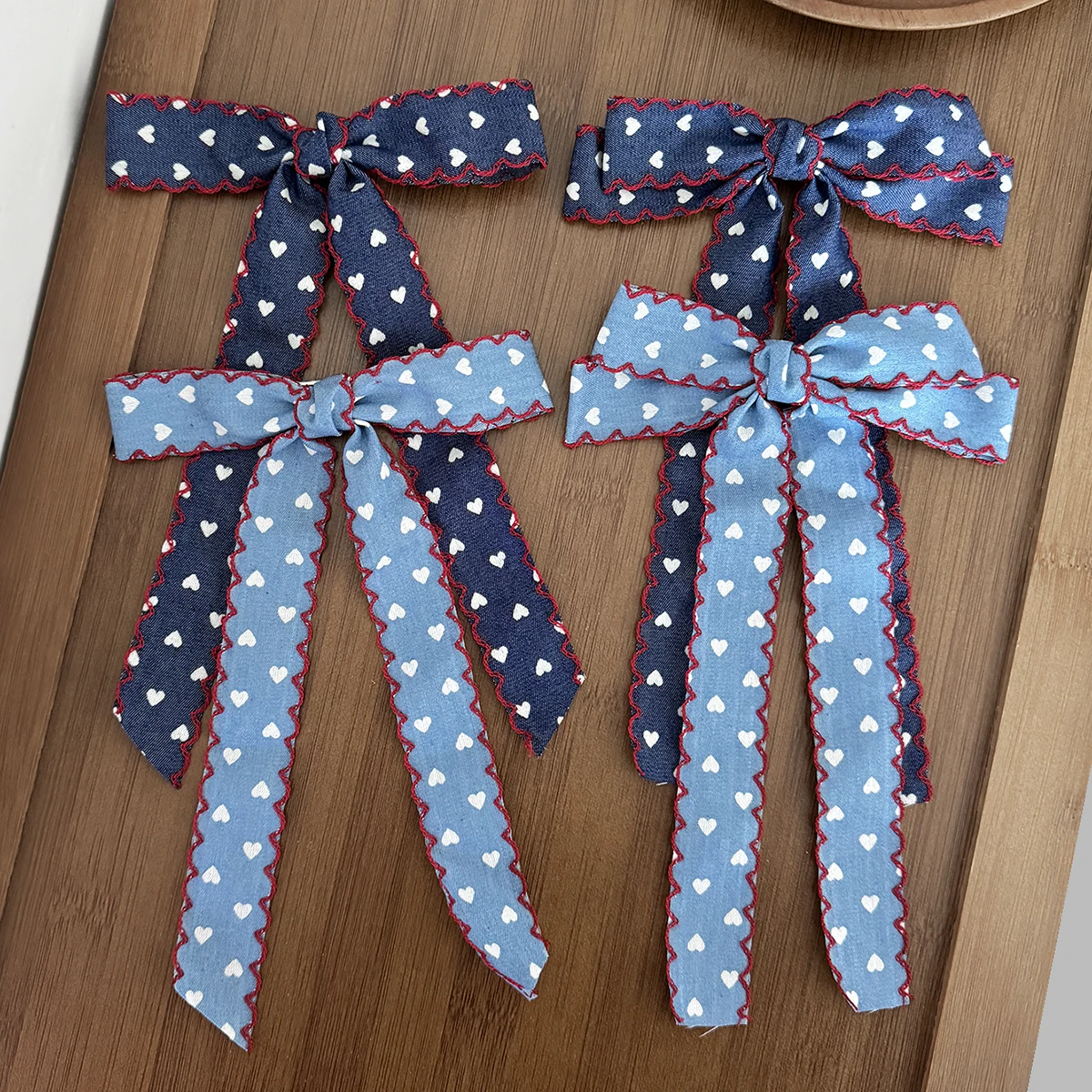 

Korean-style denim fabric heart-patterned bow hairpin for women, a fashionable and versatile hair accessory.