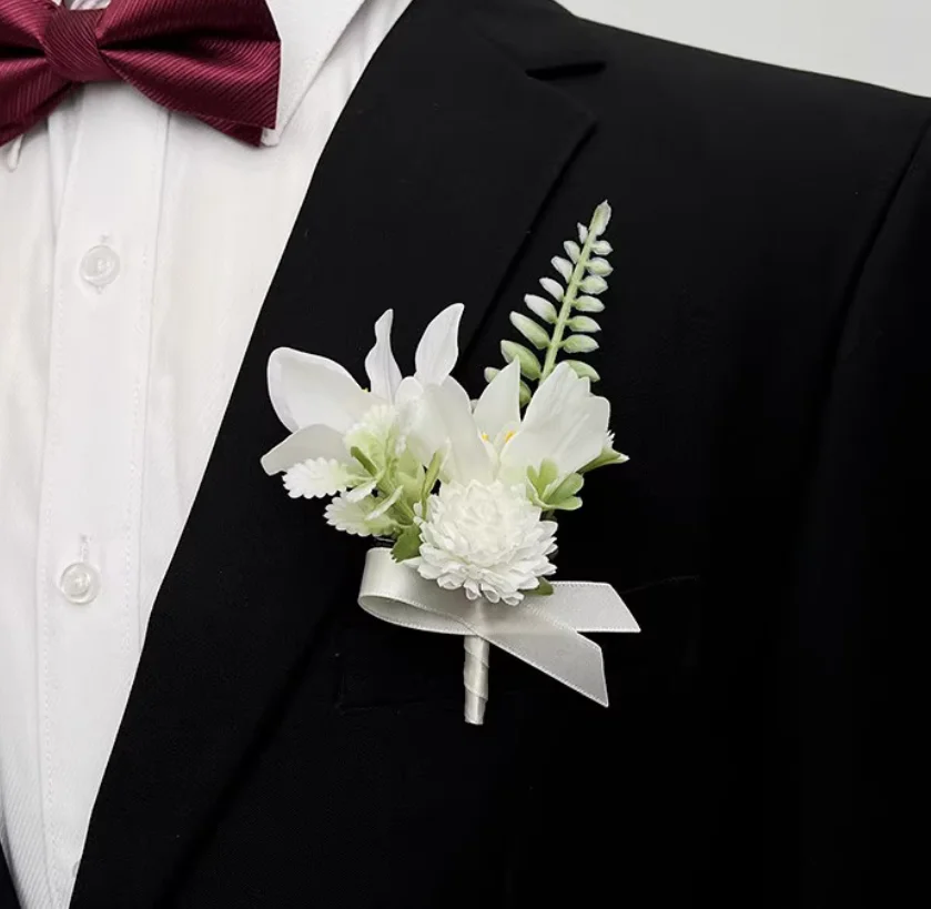 

Forest-themed wedding: white freesias, handmade tulips, boutonnieres for bride and groom, best man and maid of honor, and brooch