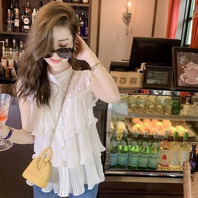 Camicia in chiffon senza maniche bianca scavata per le donne Estate nuova top trendy chic da strada con foglie di loto a pieghe larghe e impiombate