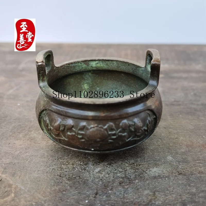 Antique-style alloy copper incense burner with a patina finish, featuring a relief peony flower design, three legs, and double h