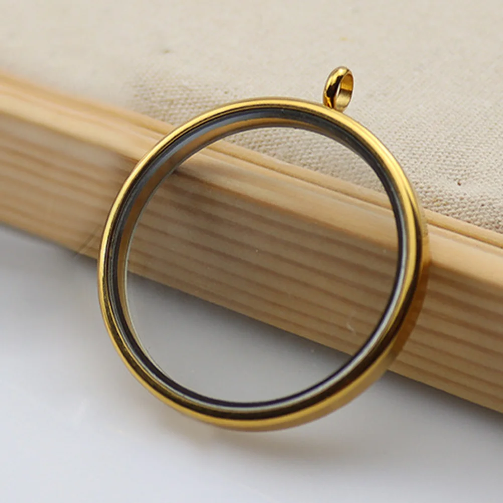 Okrągły wisiorek-medalion ze stali nierdzewnej i szkła, otwierany, do samodzielnego tworzenia naszyjników i breloków.