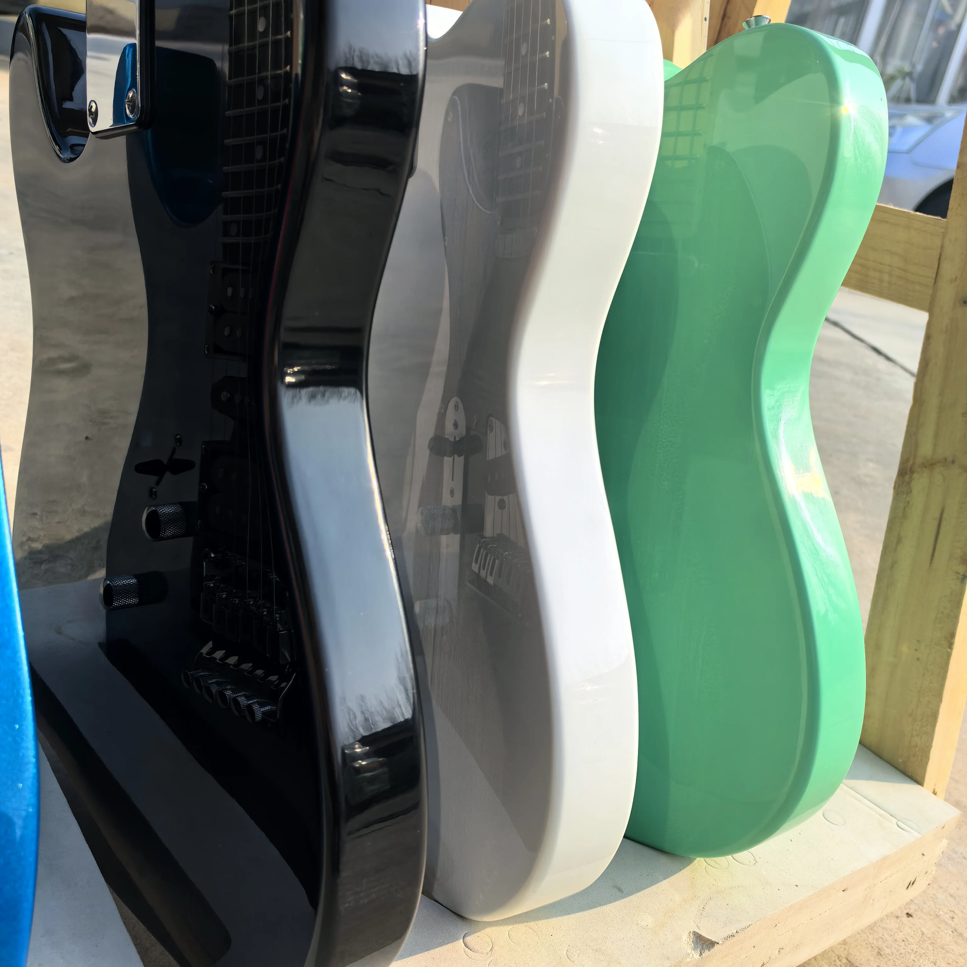 Custom colors available, end-of-line clearance: green 6-string electric guitar, with green, black, white, and sunset color