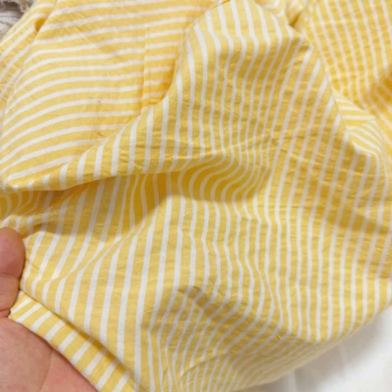 Yellow and white woven vertical stripes 0.5cm bubble pure cotton breathable texture blouse dress fabric