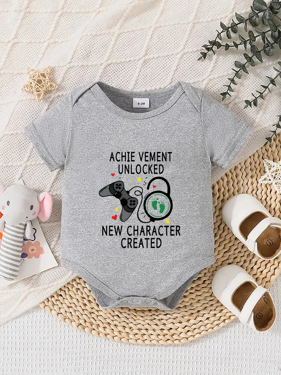 Playful letter-printed baby short-sleeve triangle bodysuit. Button closure for easy dressing