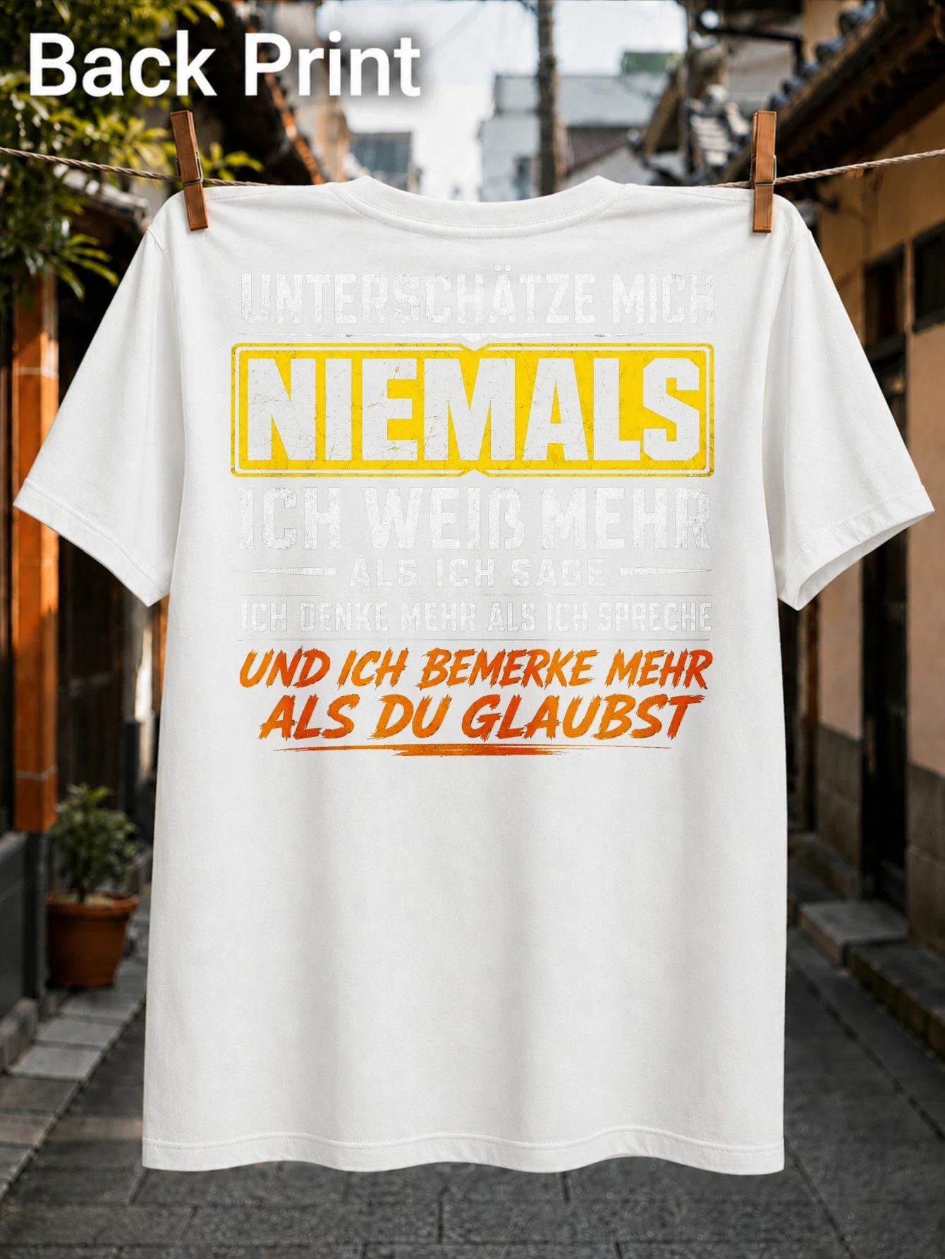 Never Underestimate Me stacked German quote with yellow warning block and orange brush text  Unisex All T-Shirt