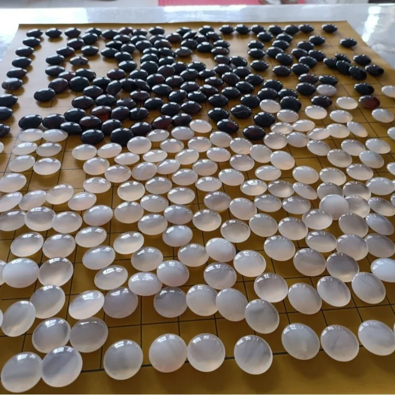 Black through red agate Go pieces plus ice, white agate Go pieces