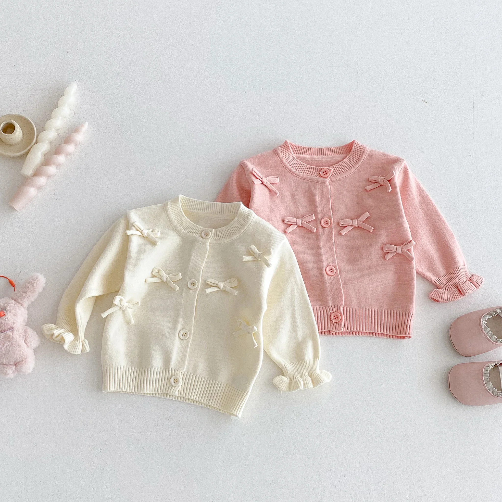 A Cute Long-Sleeved Cardigan with a Bow for a Baby Girl in Autumn