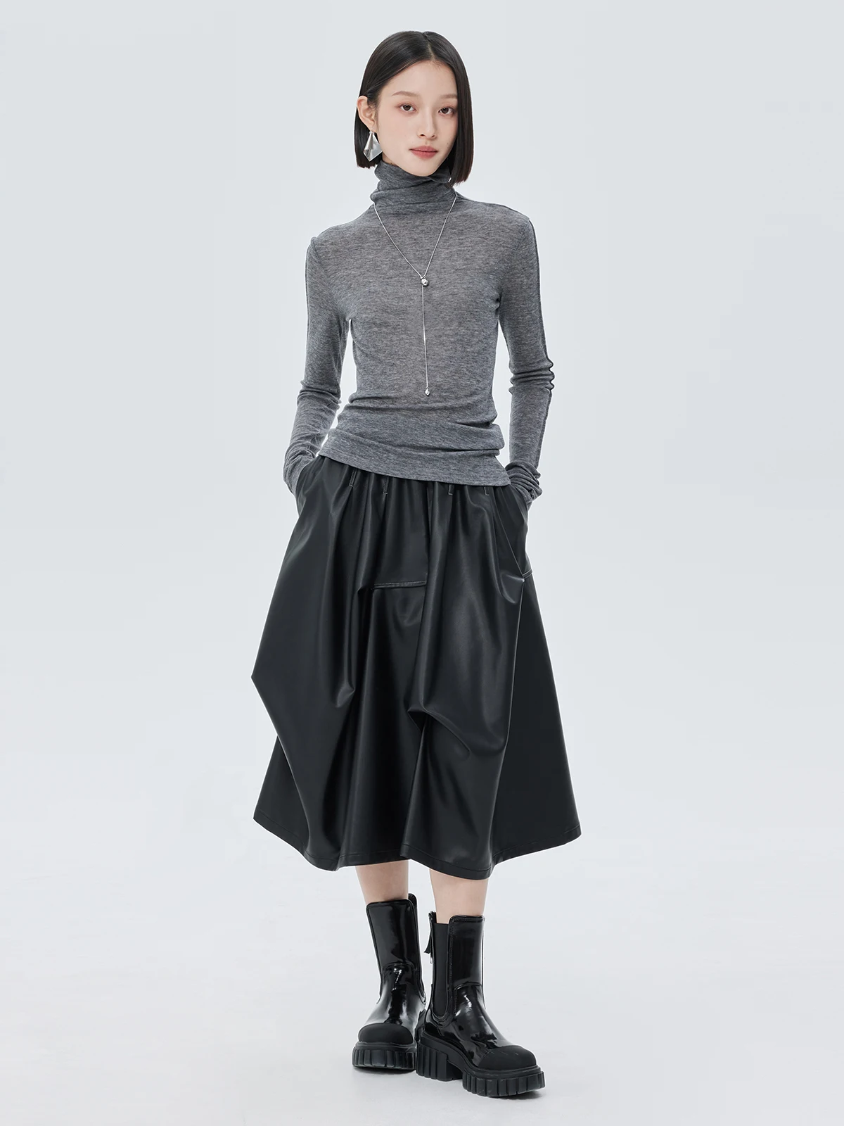 Nowa damska spódnica na jesień i zimę, czarna, asymetryczna, o średniej długości, elastyczna, z wysokim stanem, ze skóry ekologicznej (PU).