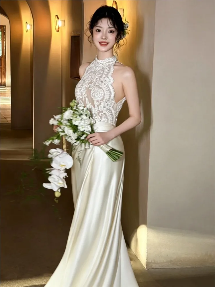 A light and stylish fishtail dress with halter-neck satin finish to welcome guests set off