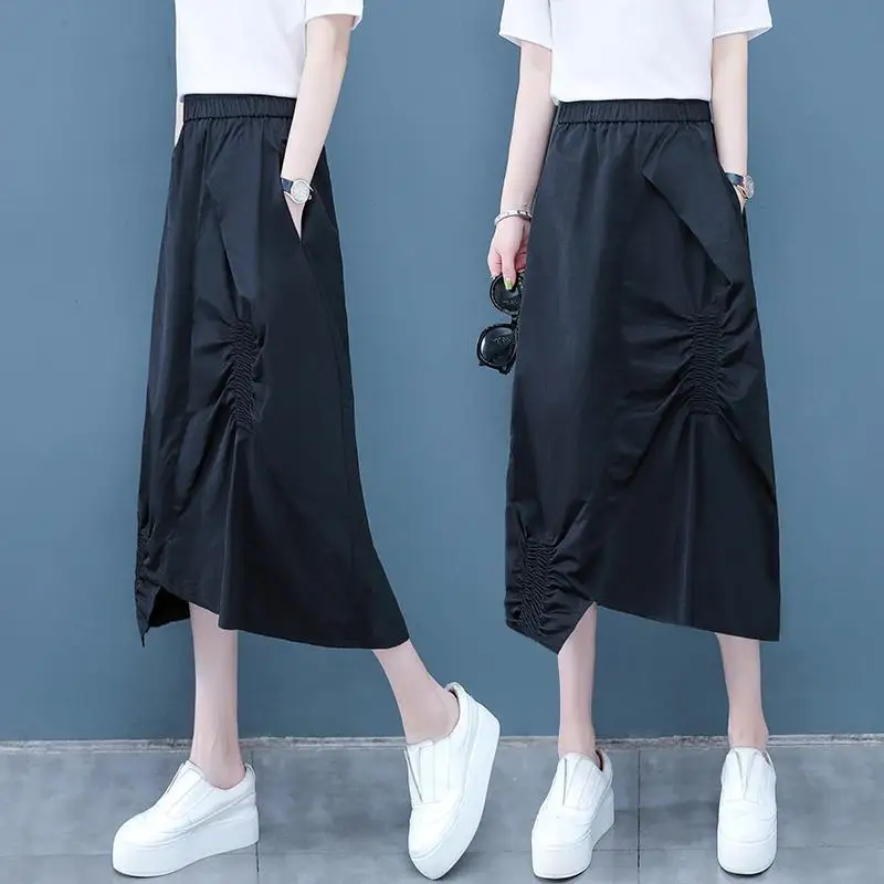 Fashion Elastic Spliced Folds Asymmetrical Skirts Women's Clothing 2024 Summer New Loose Solid Color Irregular Casual Skirts