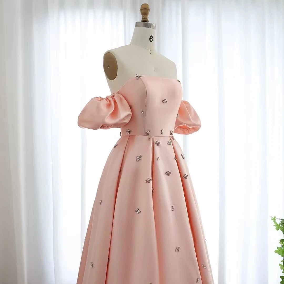 فساتين لحضور الحفلات الموسيقية باللون الوردي بدون حمالات 2025 من الساتان بأكمام منتفخة كريستال على شكل حرف a بدون ظهر مطوي بطول الأرض فساتين حفلات الزفاف حسب الطلب