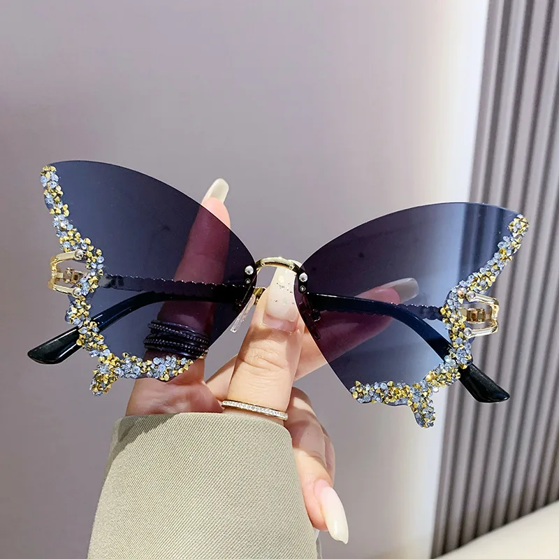 New butterfly-shaped diamond-studded rimless sunglasses for women, trendy and bold statement shades with scattered rhinestones,