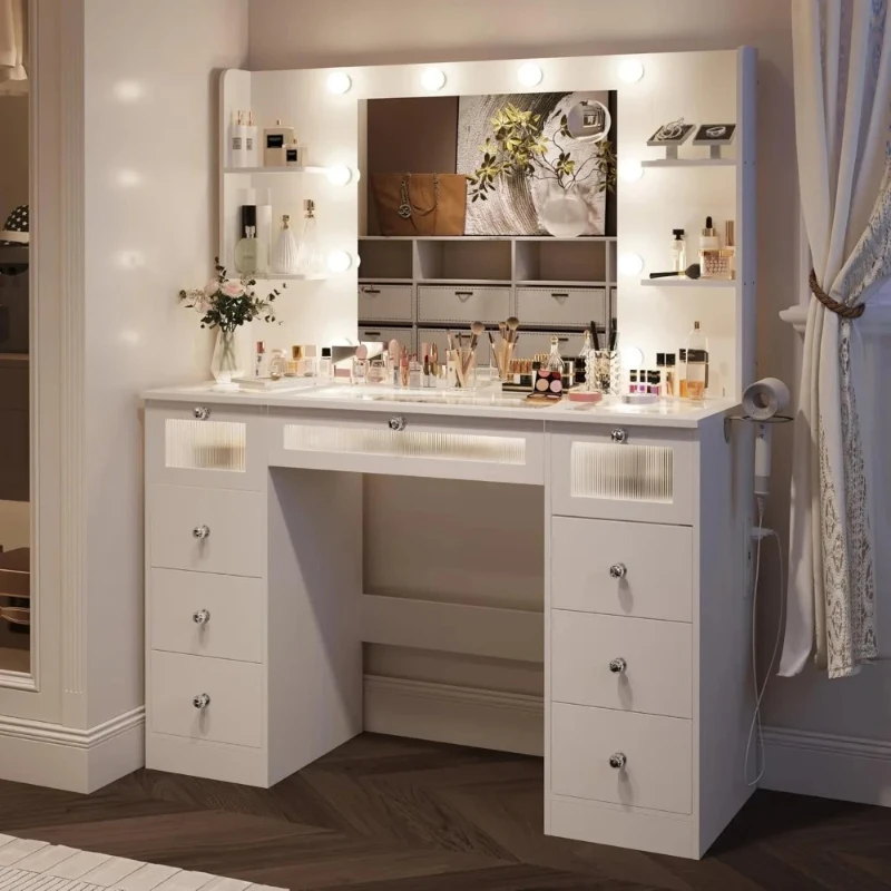 White dressing table with light colored mirror, equipped with 9 drawers, 3 colorful Hollywood light bulbs, and 4 shelves