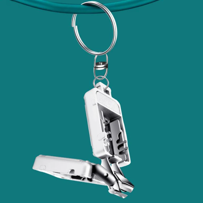 Un nuevo mini cortaúñas plegable de plata, cortaúñas portátil de viaje con llavero, herramienta de manicura