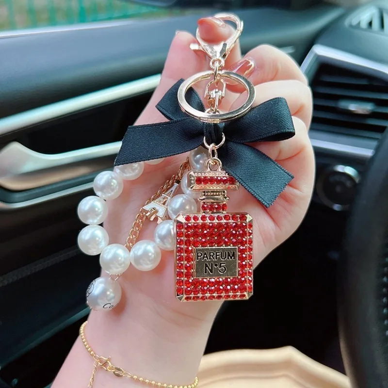 Alloy diamond inlaid bow shaped perfume bottle key chain creative pearl chain bag pendant exquisite key chain image 6