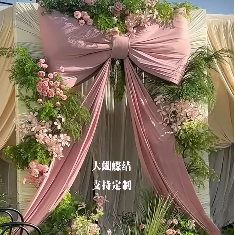 

Outdoor lawn wedding bow wedding stage background pink and white bow arrangement wedding room engagement banquet decoration