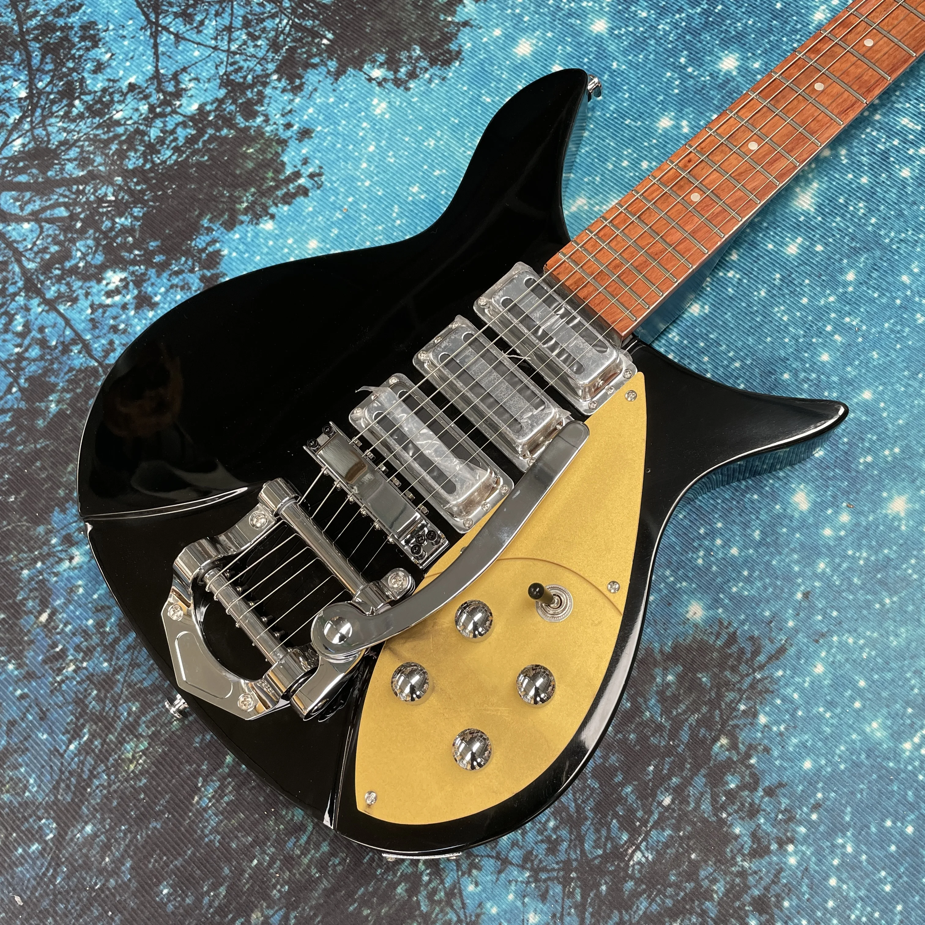 

6-струнная электрогитара, черно-белая в ретро-стиле с системой вибрато, серебристая фурнитура, рок-гитара.