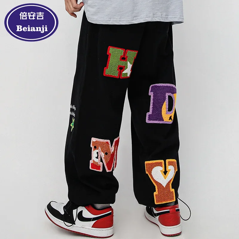 Beianji men's pants Instagram hip hop design sense letter sticker trend high street skateboard drawstring leg denim pants