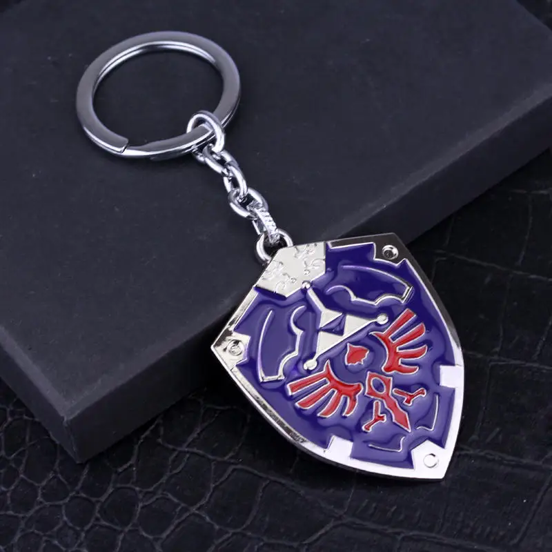 LLavero de escudo Hylian de Zeldas para hombre, colgante con símbolo de Breath of The Wild Sheikah Eye, máscara de Majora, espada y Triforce, joyería