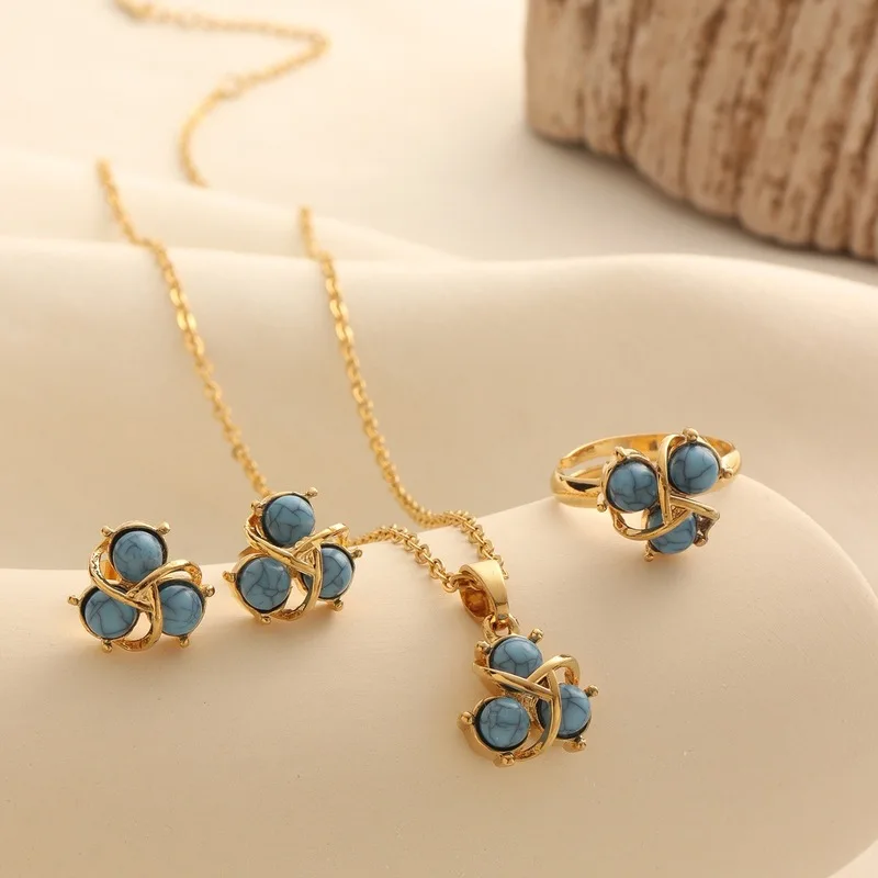 3A set of blue turquoise and gold-plated jewelry, including a necklace, earrings, and a ring, with turquoise accents