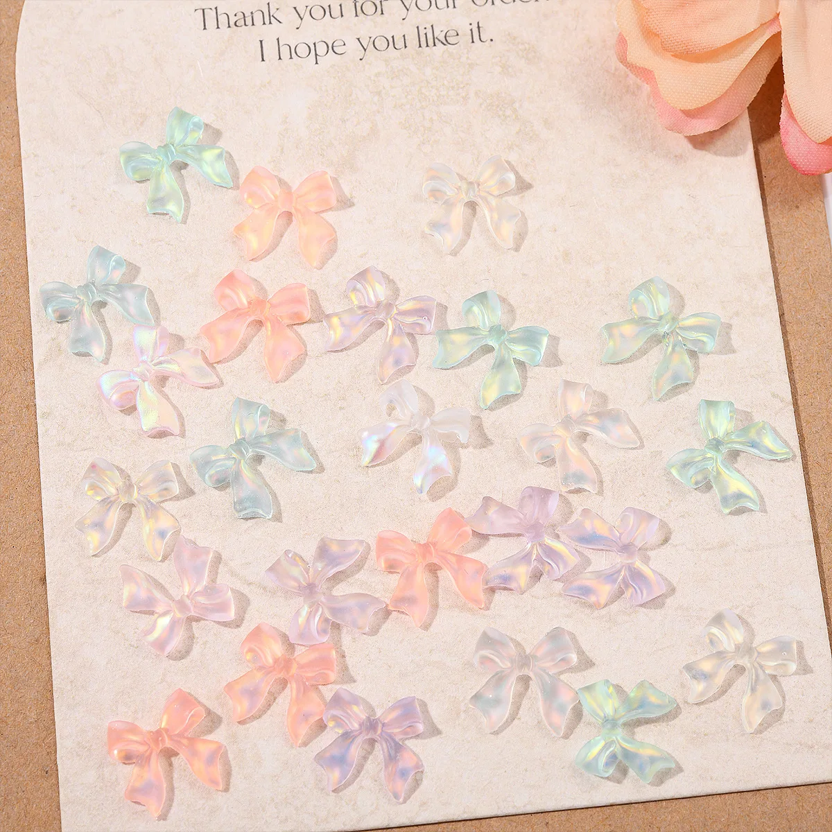 ชาร์มตกแต่งเล็บริบบิ้นออโรร่ามอคค่า 50 ชิ้น คละสี อุปกรณ์ตกแต่งเล็บ 3 มิติ เรซิ่น ประดับเล็บ อุปกรณ์ทำเล็บ